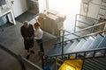 Gray-haired man signs a contract in a warehouse Royalty Free Stock Photo