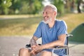 A gray-haired man in a wheel chair in the park Royalty Free Stock Photo