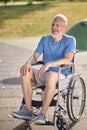 A gray-haired man in a wheel chair in the park Royalty Free Stock Photo