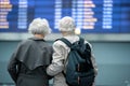 Gray-haired pleasant couple is waiting for their flight Royalty Free Stock Photo