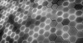 Gray hexagons glowing with white light on a black background