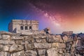 Gray iguana sitting on the stone wall of Mayan Ruins of The Castle in Tulum, Riviera Maya, Yucatan, Caribbean Sea, Mexico with Royalty Free Stock Photo