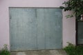 Gray iron gate on pink concrete wall