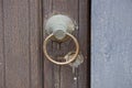 Gray iron round old door handle on a wooden wicket board