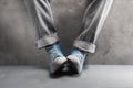 Gray jeans with nice sneakers on concrete background Royalty Free Stock Photo