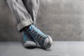 Gray jeans with nice sneakers on concrete background Royalty Free Stock Photo