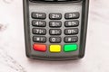 Gray keypad of contactless payment terminal standing on marble table, background, copy space Royalty Free Stock Photo
