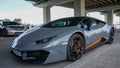 Gray lamborghini sports car stands in a parking lot under a bridge in Seoul city front view