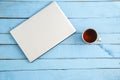 Gray laptop and a Cup of drink on a blue wooden background. the view from the top Royalty Free Stock Photo