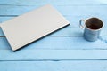 Gray laptop and a Cup of drink on a blue wooden background. the view from the top Royalty Free Stock Photo