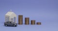 Gray machine model and home with coins in the form of a histogram on a purple background. Concept of lending, savings, sale, lease