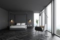 Gray master bedroom interior with armchair