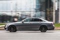 Gray Mercedes-Benz E-Class car moving on the street. Luxury saloon car Mercedes W213 in motion, side view Royalty Free Stock Photo