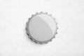 Gray metal beer lid, soda cap, bottle cover on white paper background