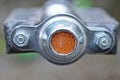 Bicycle pedal part with plastic dirty orange reflector Royalty Free Stock Photo