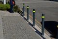 Gray metal bollards are used to protect pedestrians in the pedestrian