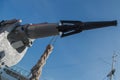 Gray metal cannon-harpoon with a black tip mounted in the mouth a holder with a braided rope attached to it against the blue sky Royalty Free Stock Photo