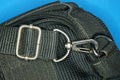 Gray metal carabiner latch on a black harness bag Royalty Free Stock Photo