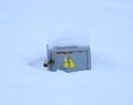 Gray metal electrical panel covered with snow with a high voltage danger sign Royalty Free Stock Photo