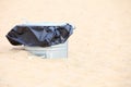 Gray metal garbage bin or can on beach Royalty Free Stock Photo