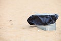 Gray metal garbage bin or can on beach Royalty Free Stock Photo