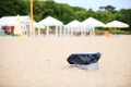 Gray metal garbage bin or can on beach Royalty Free Stock Photo