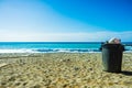 Garbage bin trash can on beach Royalty Free Stock Photo