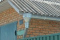 Gray metal gutter pipe on a brown brick wall Royalty Free Stock Photo