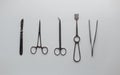 Gray metal medical instruments for neurosurgery on a white table in the operating room. View from above.