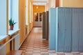 Gray metal outdated lockers in the empty school corridor of the old school Royalty Free Stock Photo