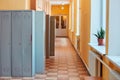 Gray metal outdated lockers in the empty school corridor of the old school Royalty Free Stock Photo