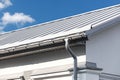 Gray metal roof with gutter and drainpipe