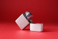 Gray metallic cigarette lighter on red background