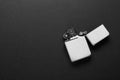 Gray metallic cigarette lighter on black background, top view. Space for text Royalty Free Stock Photo