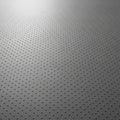Gray metallic surface with a uniform pattern of small, raised dots in a grid formation. Royalty Free Stock Photo