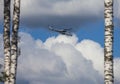 Gray Mi-24 helicopter with the UN identification inscription against the background of clouds in the summer sky Royalty Free Stock Photo