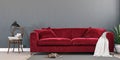 Gray mock up wall with luxury carmine red sofa in modern interior background, living room, Scandinavian style Royalty Free Stock Photo