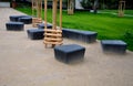 Gray monolithic concrete park bench made of concrete in the shape of round stones anthracite color park paths and interlocking pav Royalty Free Stock Photo