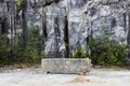 Gray natural marble with white streaks in the canyon, deposit, Karelia. A stone bar in the form of a bench rests on