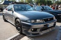 gray ninth-generation Nissan Skyline GT R33 at a Japanese sports car meet.