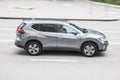 Gray Nissan X-Trail SUV driving in Moscow city. This is first compact crossover produced by Japan car brand