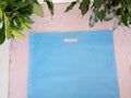 Blue Non Woven Bag Isolated on table. Eco Bags with leaves. Tote bag gift for you Royalty Free Stock Photo