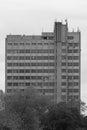 Gray office multi-storey tall concrete building in the style of modernism.