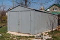 Gray old metal garage for a car, standing on the street Royalty Free Stock Photo