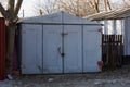 Gray old metal garage standing on a city street Royalty Free Stock Photo