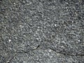 The gray old stucco is covered with small stones. Deep cracks are visible on the plaster Royalty Free Stock Photo