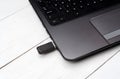 Gray open laptop computer with flash drive in the connector. Royalty Free Stock Photo