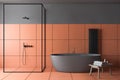 Gray and orange tile bathroom, tub and shower