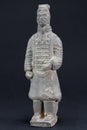 Gray oriental man statuette over black background