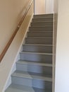 Gray painted stairs with hand rail